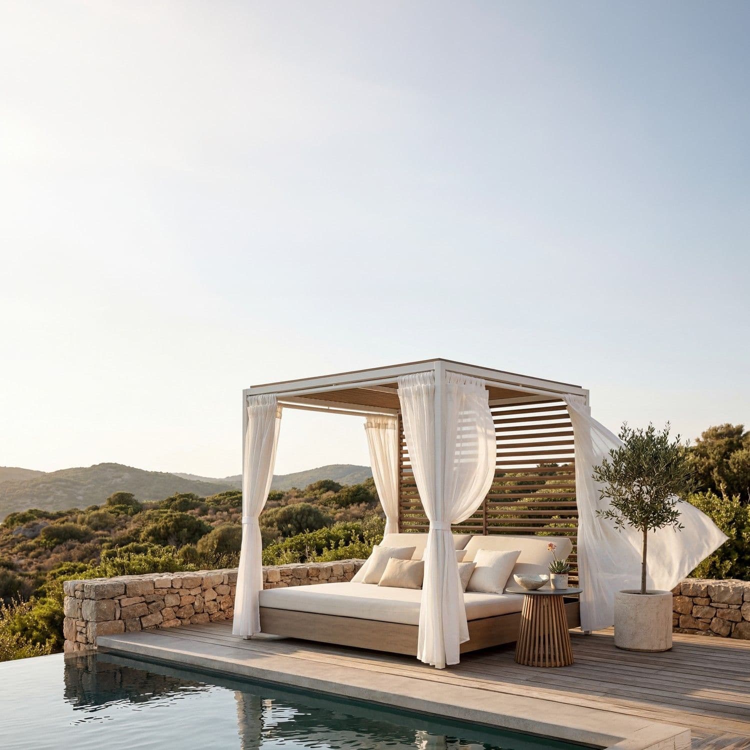 BLOOM Elios luxury outdoor daybed cabana by an infinity pool, overlooking a serene coastal landscape. Premium designer lounge