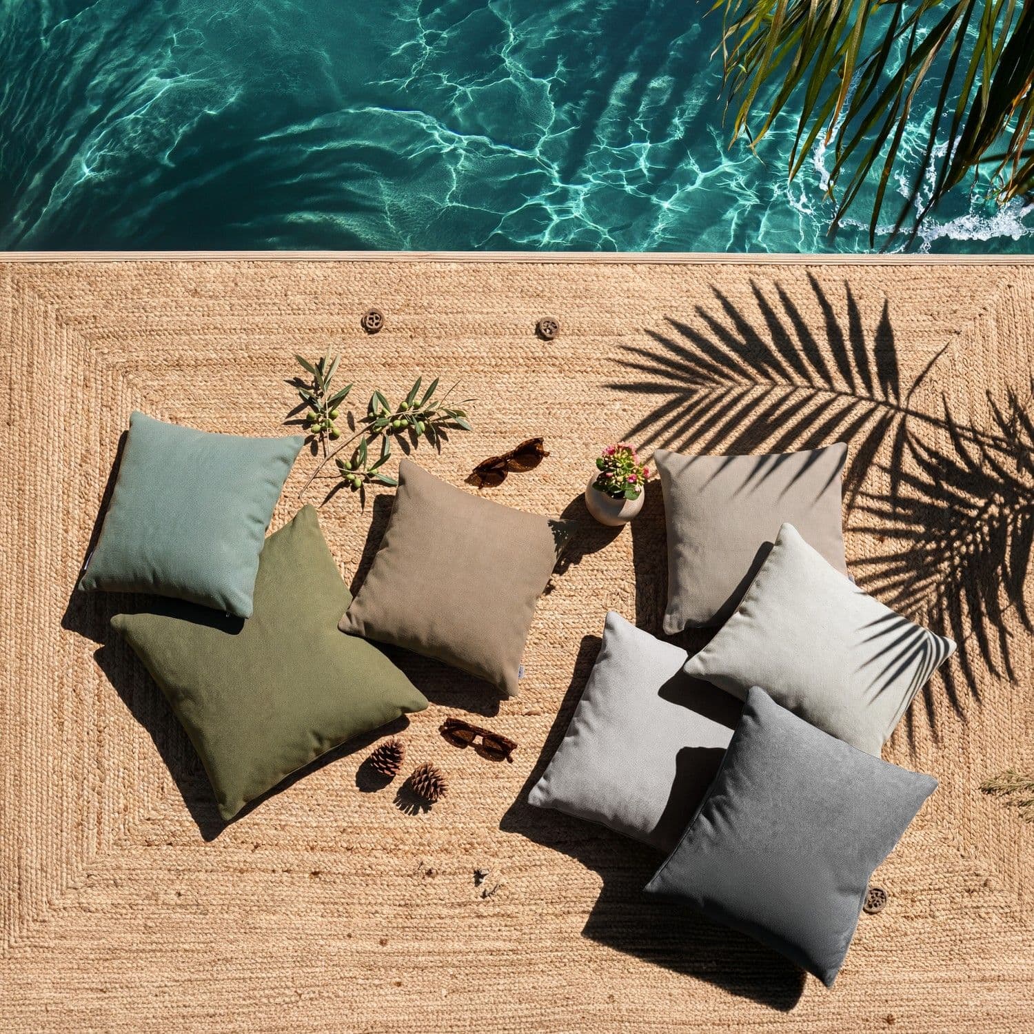 BLOOM Scatter Pillows collection: luxury outdoor cushions in earthy tones on a natural rug, perfect for a designer terrace or