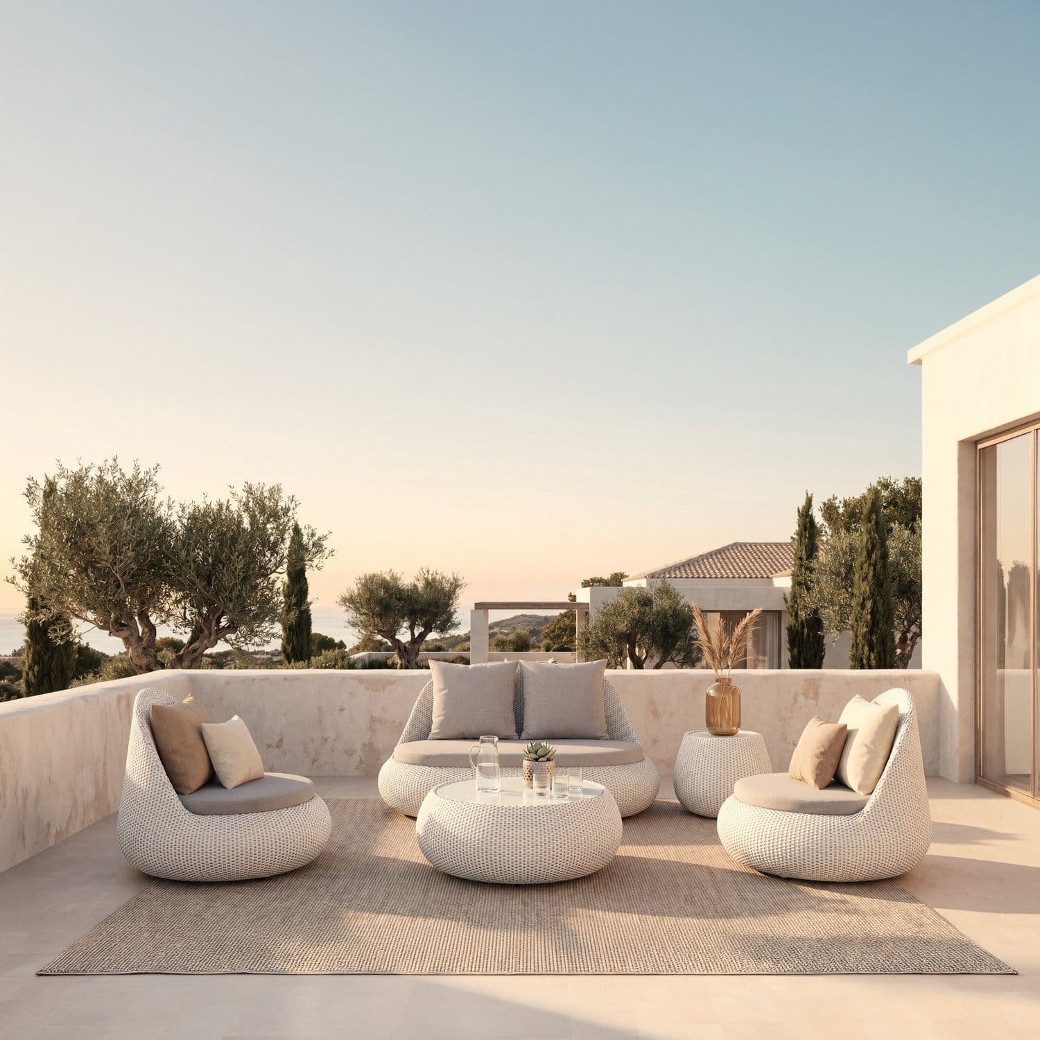 BLOOM Onyx luxury woven lounge set on a Mediterranean terrace with sea view. Premium outdoor furniture for exclusive designer
