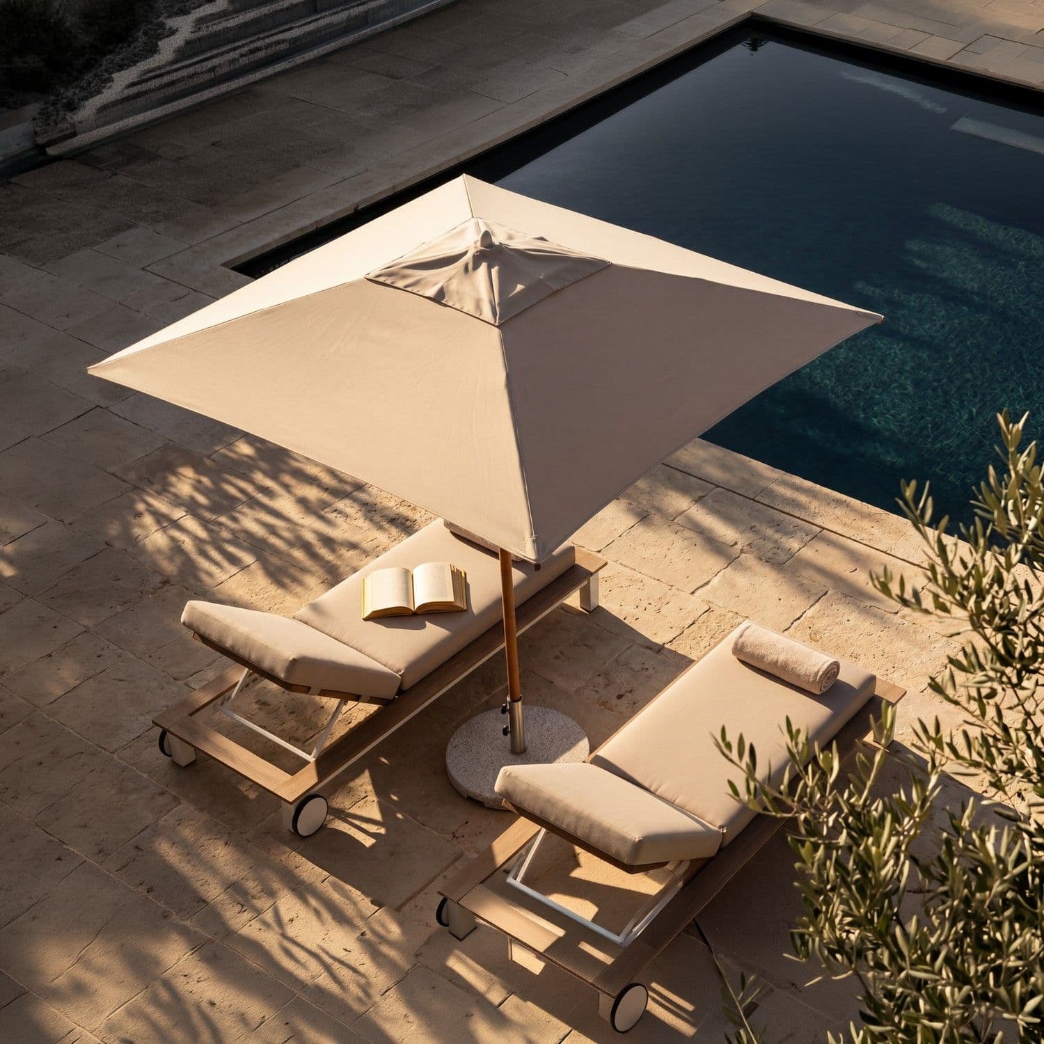 BLOOM Vertex luxury teak sun loungers & umbrella by a serene pool. Premium outdoor furniture for exclusive resorts & private